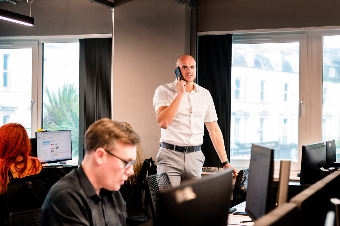 Kemp team member on a phone in an office